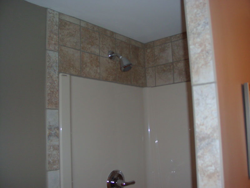 New full bath showing tile above shower insert.