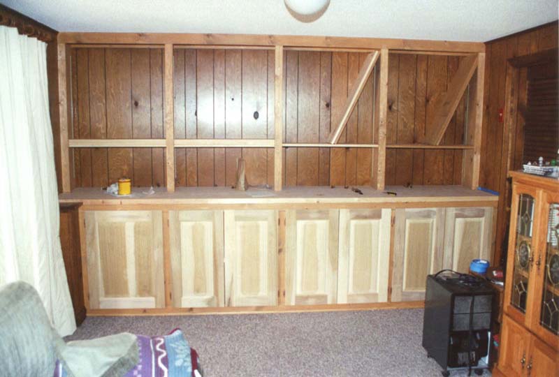 Built-in cabinets and shelving being installed, prior to finishing.